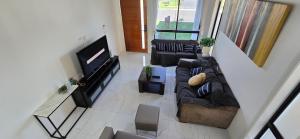 a living room with a couch and a flat screen tv at New 5x bedroom The Ponds House in Schofields