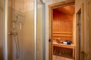 a shower with a glass door in a bathroom at Typ H "Lord Nelson" -Sundhaus- in Pelzerhaken