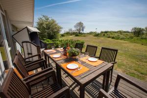 a wooden table on the back porch of a house at Typ H "Lord Nelson" -Sundhaus- in Pelzerhaken