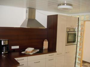a kitchen with a sink and a stove top oven at Kietzke in Eckernförde