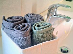 a basket of towels sitting next to a sink at Luxury Villa Azure in Larnaca +23 photos
