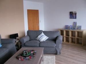 a living room with two couches and a coffee table at Ferienwohnung Oelstorf in Eckernförde