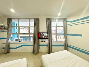 Postel nebo postele na pokoji v ubytování One Stop Hotel Ipoh