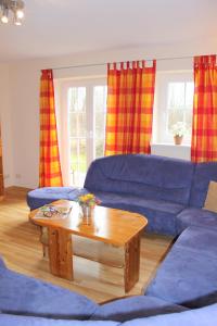 a living room with a blue couch and a coffee table at "Hof Triangel - Whg 3" - Bauernhofurlaub in Riepsdorf