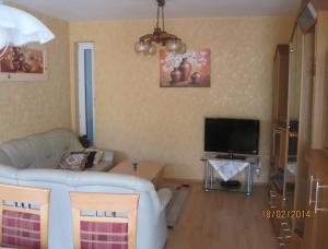 a living room with a couch and a tv at Ferienwohnung-Haus-Perkow in Illingen