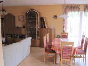 a dining room with a table and a china cabinet at Ferienwohnung-Haus-Perkow in Illingen +11 photos