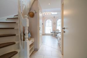 a hallway with stairs leading to a dining room at Ostseeidyll in Zingst