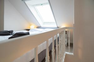 a attic bedroom with two beds and a skylight at Ostseeidyll in Zingst +9 photos