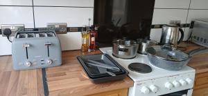 a kitchen with a stove and a toaster on a counter at Ipswich Town 3 Bed House in Copdock +9 photos