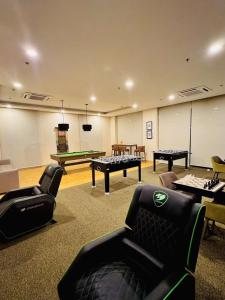 a room with couches and ping pong tables at Opulent Spacious 3 BR Condominium at St Dominique at Megaworld in Iloilo City