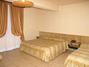 Letto o letti in una camera di Hotel Tre Torri