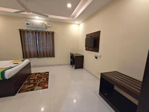 a room with a bed and a tv on the wall at SIRI Tals Hitech in Hyderabad +9 photos