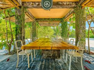 a wooden table and chairs on a patio at Luxury Oceanfront Villa - Private Pool -Temazacal in Chamela