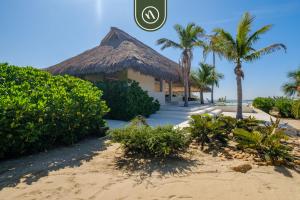 a resort on the beach with palm trees at Stunning Two-bedroom Ocean View House - Mazul in Tlachicón