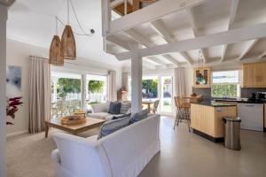 a living room with a white couch and a table at 4188 River Club in Plettenberg Bay
