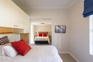a bedroom with a bed with red pillows at 4188 River Club in Plettenberg Bay
