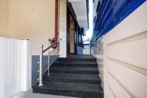 a staircase in a building with a blue curtain at Super Hotel O Lalganesh formerly Royal Avenue in Guwahati