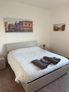 a bedroom with a bed with two towels on it at Villa Cecilia in Portogruaro