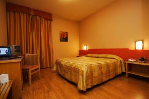 Letto o letti in una camera di Hotel Tre Torri