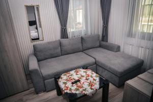 a living room with a couch and a table at HOTEL GOLDEN CITY in Zlatograd