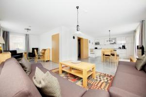 a living room with a couch and a table at Kapitänshaus in Waabs