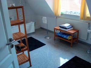a attic room with a ladder and a table with towels at Ferienhaus am Nord-Ostsee-Kanal in Sehestedt