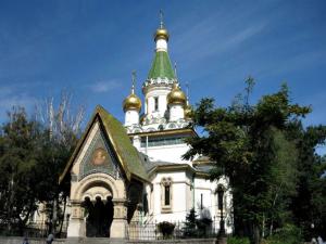 a building with a steeple with gold domes on it at THE GOOD PLACE - historical center, unique in Sofia
