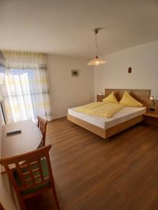 a bedroom with a bed with yellow pillows on it at Haus Evi in Termeno