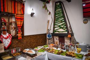 a buffet of food with a christmas tree on the wall at HOTEL GOLDEN CITY in Zlatograd