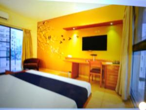Ένα ή περισσότερα κρεβάτια σε δωμάτιο στο Astra Hotels & Suites - Marathahalli SG