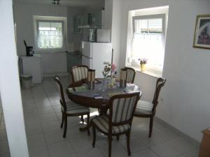 a kitchen with a table and chairs in a kitchen at Ferienhaus Nr1 in Balatonszárszó