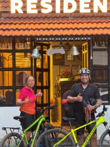 a man and a woman standing next to two bikes at David Residency in Madurai