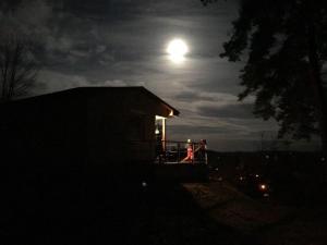 two people sitting on a porch of a house at night at Ferienhaus Marie- Louise in Amtshof