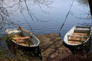 two boats tied up to a dock on the water at Ferienhaus Marie- Louise in Amtshof +7 photos