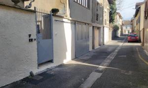 an alley with doors on the side of a building at Le Repos du Mélomane - A 1h de Lyon climatisé in La Côte-Saint-André
