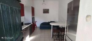 a small kitchen with a table and a counter top at Robinson Mili in Bogomolje