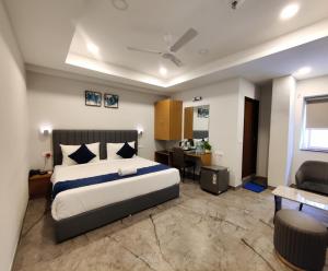 a bedroom with a large bed and a desk at Yellow Sapphire Hotel Gachibowli in Hyderabad +26 photos