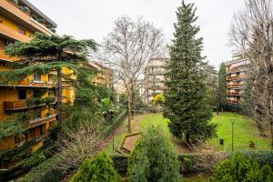 Un jardín de apartamentos con árboles y edificios. en Near Airport 8 Guests - Big Elegant Apartment, en Florencia