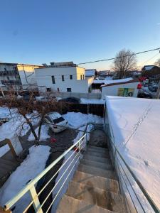 a stairway in a city with snow on the ground at Vila cu garsoniere in Bucharest