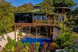 a house with a swimming pool in front of a house at Simroseate in Agonda