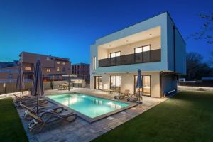 a house with a swimming pool in the backyard at Villa Mila - NEW 2025 in Medulin