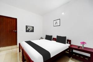 Postel nebo postele na pokoji v ubytování Super Hotel O Sultan Bathery formerly Bluevalley