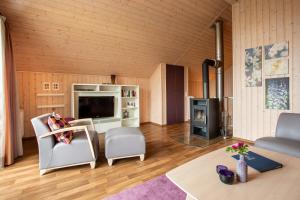 a living room with a fireplace and a stove at Typ F "John Flint" -Kapitänshaus- in Pelzerhaken