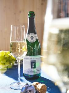 a bottle of wine and a glass on a table at Typ F "John Flint" -Kapitänshaus- in Pelzerhaken +15 photos