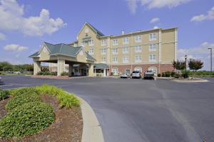 un grand hôtel avec des voitures garées dans un parking dans l'établissement Country Inn & Suites by Radisson, Orangeburg, SC, à Orangeburg