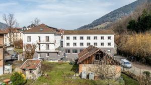 a group of buildings in a town with a mountain at Le Dauphiné 2 - Allevard in Allevard