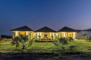 a house lit up at night at Sterling Tipeshwar in Pahāpal