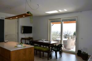 a kitchen and dining room with a table and chairs at Villetta Giare in Posina