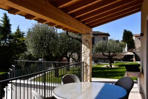 a patio with a table and chairs on a porch at Villetta Giare in Posina