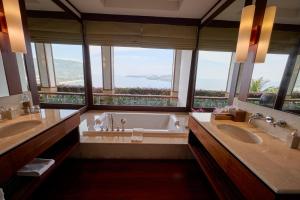 a bathroom with two sinks and a tub with windows at Villa 29 Montebello Andara Resort Villas in Kamala Beach +25 photos